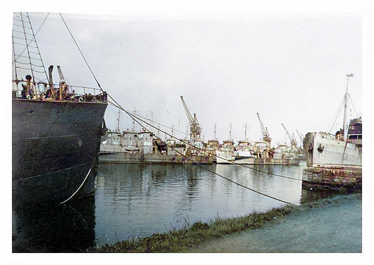 1943-4 - A photograph taken from the southern side of the dock toward the LST's moored up in regimental rows against the northern quay wall. 