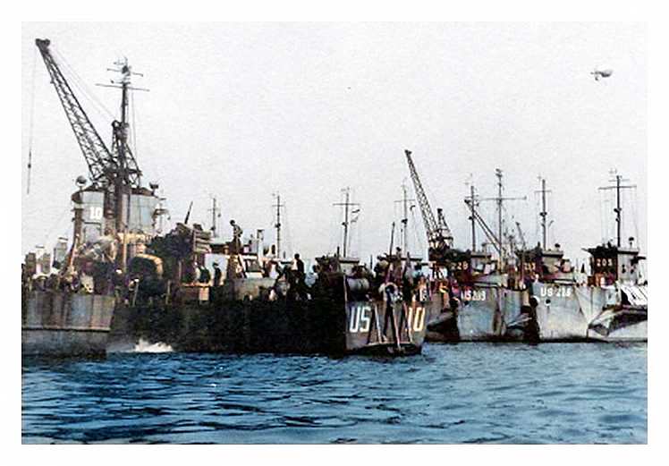 1943-4 - A view of the stern of LST US-10 with the bows of US-218 and US-209 visible.