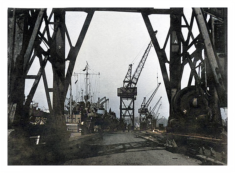 1943-4 - Back at the northern quay of the Penarth Dock and a view through a crane at LST US-262 awaiting the call to duty. 