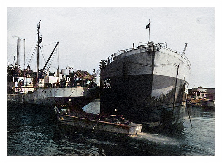1943-4 - A photograph of LST US-262 at anchor apparently in contact with the stern of freighter at Penarth Dock.
