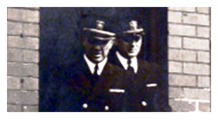 1943-4 - A view showing two U.S. Navy officials leaving the administration building at Penarth Dock. 