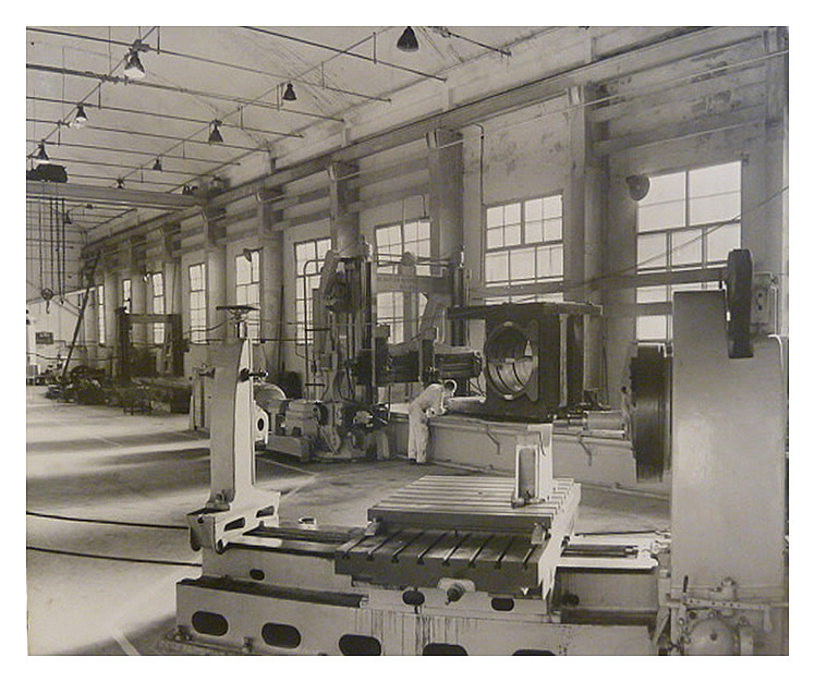 1970s - 80s - A photograph of the main machine shop with a large bearing housing on the large planer bed.