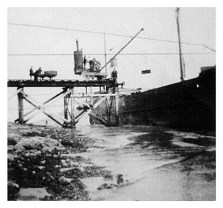 off loading operation using a steam crane of two cast iron tunnel segments from the steamship 'Cailey Fowlough' at the river Ely jetty especially built for the subway works