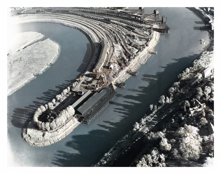 1955 - An aerial view of the meandering River Ely with the Victoria Wharf of the South Wales Warehouses Limited and associated warehouse and rail facilities. 
