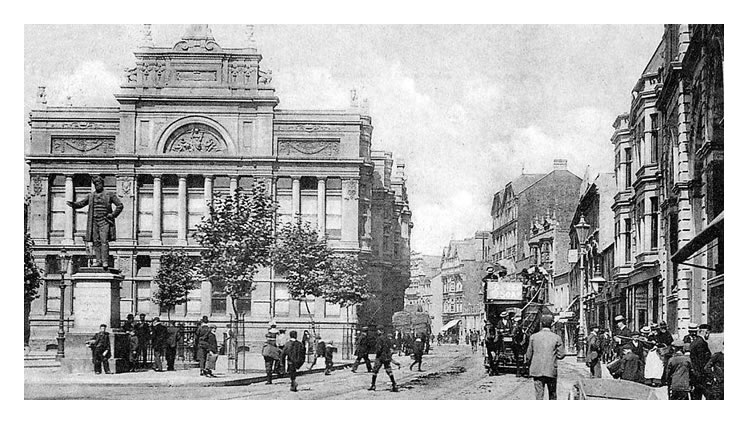 The statue of John Batchelor standing in the Hayes, Cardiff outside the Free Library.
