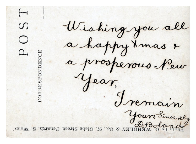 Photograph of a boy and a bicycle as published in postcard format by G. Wehrley & Co., 97, Glebe Street, Penarth, S. Wales. The Xmas wishes were penned by a D. Boland! 