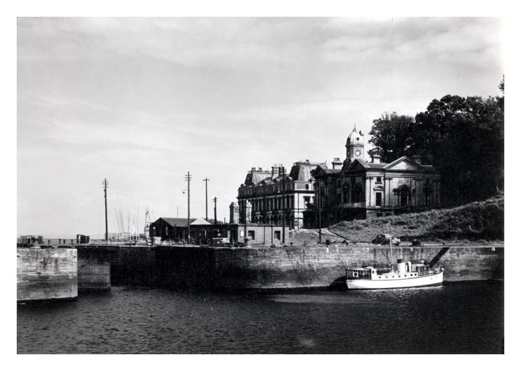 1950's - Penarth - Entrance to Docks - 'Above the quay is the old Customs House. The docks which cover 26 acres were opened in 1865. Photograph by Raymond Moore.' 